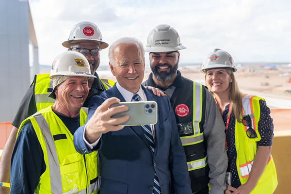 President Joe Biden poses for a selfie with workers in Phoenix-AZ